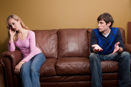 A couple has an argument on the couch