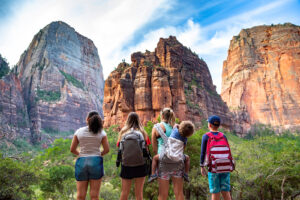 A family look at a rocky landscape on a sunny day. Learn how a parenting counselor in Arcadia, AZ can offer support by searching for family counseling Phoenix or internal family systems therapy in Arcadia, AZ today.
