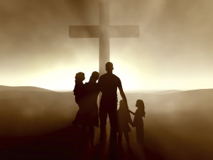 A family of 5 stands in front of a cross. This could represent the support cultivated by working with a therapist in Arcadia, AZ. Learn more about Crossroads family counseling by searching “Christian marriage counseling Phoenix“ or contacting an anthem therapist near me. 