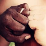 A close up of two hands with wedding bands. This could represent the deeper connection cultivated by a premarital counselor in Phoenix, AZ. Learn more about premarital counseling in Phoenix, AZ by contacting a therapist in Arcadia, AZ today.
