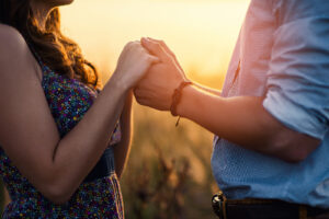 A close up of a couple holding hands, represnting the bond couples therapy in Phoenix, AZ can cultivate. Learn more about christian marriage counseling Phoenix by searching "christian marriage counseling az" today.