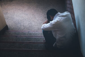A person sits on steps with their head resting against their arms. Depression treatment in Arcadia, AZ can help you overcome past effects of depression. Learn more about how a child therapist in Phoenix, AZ can offer support by searching "child counseling Phoenix AZ" to learn more.
