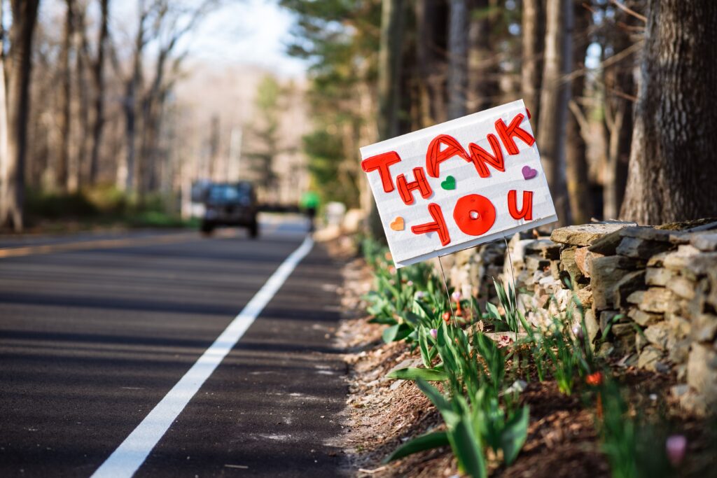 A close up of a road sign that says “thank you” with heart stickers. This could represent gratitude for first responders. Learn how grief counseling in Phoenix, AZ can offer support by contacting a therapist in Phoenix, AZ today.